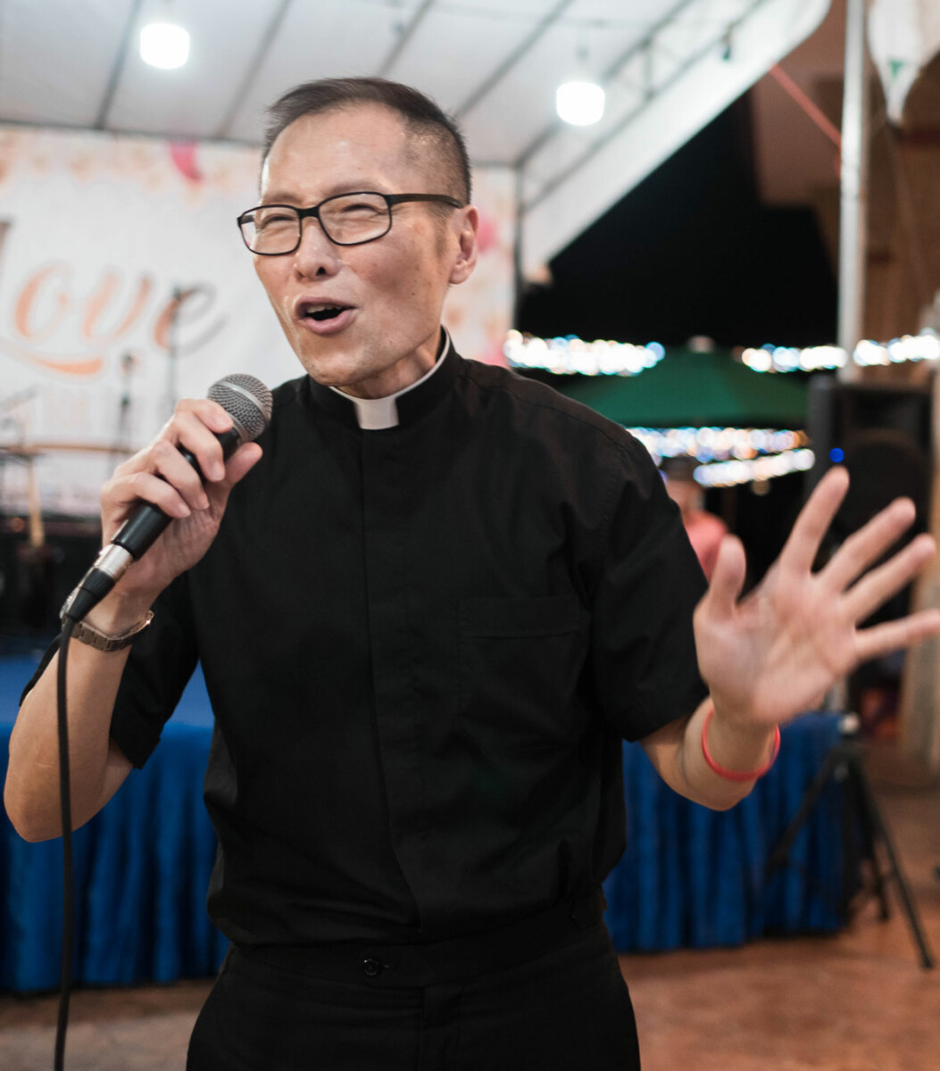 Fr Luke belting out a song at the IHM Family Fiesta 2019